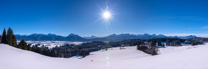 Fototapeta na wymiar beautiful panoramic landscape wirh mountain range in Bavaria, Germany, at cold winter day