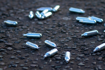 Empty and discarded laughing gas continers