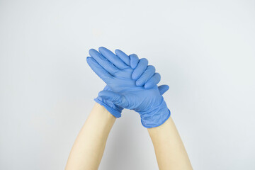 hands in rubber medical gloves raised up close up