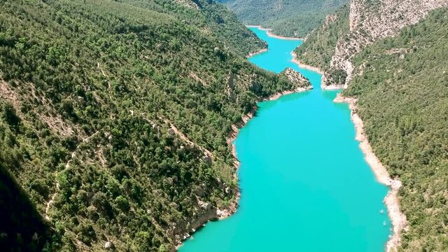 Water flow along the valley of Spain, Catalonia forest, drone moving over the Catalonia river