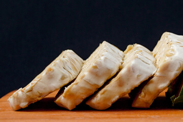 tempeh wrapped in banana leaves and tempeh slices on a wooden cutting board