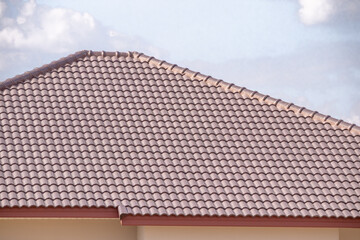 Ceramic roof tiles on the house with blue sky
