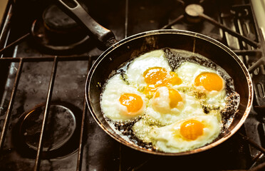 Fried eggs in the pan on the gas stove