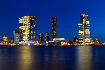 Fototapeta na wymiar City Landscape - view of the embankment with skyscrapers in Rotterdam at night, The Netherlands, December 28, 2017