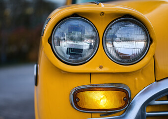 headlights of yellow vintage car