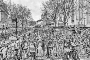Cityscape on a winter day, in black-and-white color - view of the bike parking in the historic center of Amsterdam, The Netherlands