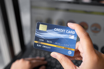 Woman holding credit card on laptop. shopping online payment concept.