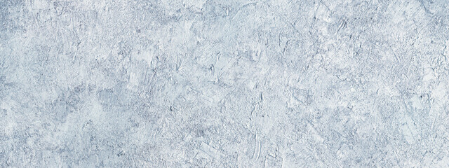 Obraz premium Abstract light blue plastered textured grunge background, horizontal banner, in the form of a rough covered stucco wall, closeup
