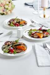 Beautifully decorated catering banquet table with different food snacks and appetizers