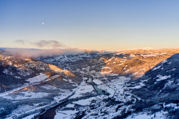 Drone photo from winter land Norway, Gol, Hallingdal. Shot in the cold in January in the blue hours early morning. Sun is rising and the frozen landscape is thawing.  © SteinOve