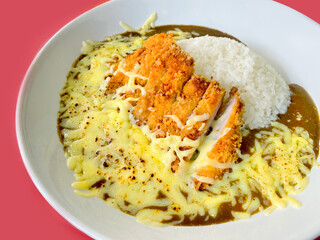 Closed up of Japanese curry rice with fried pork and mozzarella cheese, serving on white plate, Japanese traditional food