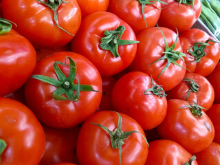 New harvest bright red tomatoes at the supermarket, food economy and vegetable prices in the market, staple food tomatoes