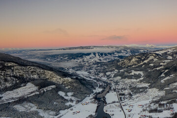 Drone photo from winter land Norway, Gol, Hallingdal. Shot in the cold in January in the blue hours early morning. Sun is rising and the frozen landscape is thawing.  © SteinOve