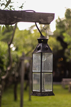 Lantern in the park. Close-up. Lantern design. Park decor elements. Blue sky. Trees and park greenery