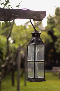 Lantern in the park. Close-up. Lantern design. Park decor elements. Blue sky. Trees and park greenery