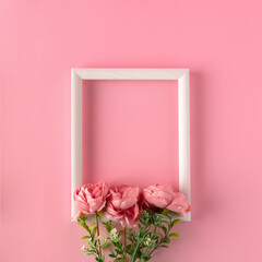 Valentine day greeting card with wooden frame and flowers on pink background