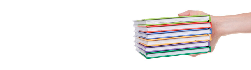 Hand with stack of colored books, isolated on white background.
