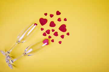 Happy Valentine's Day flatlay. Top view bottle of rose champagne in gift box, hearts, glasses on yellow color of the year 2021 background. Valentine day or New Year greeting card