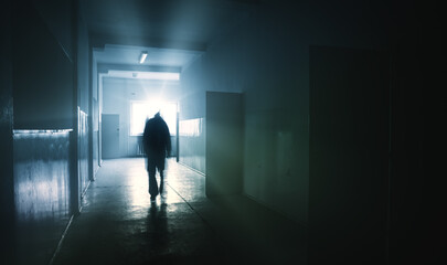 silhouette of a person in a corridor - obrazy, fototapety, plakaty