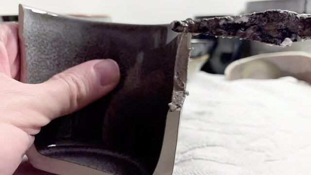 Artisan working on kintsugi process. Slow motion cinematic Kintsukuroi video. Rebuilding phase.