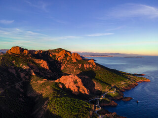Fototapeta na wymiar Massif de l'Esterel Aerial view during sunset, showing Cannes in the background with blue sky showing pine tree forest in the French Riviera, close to Cannes in Côte d'Azur, South of France