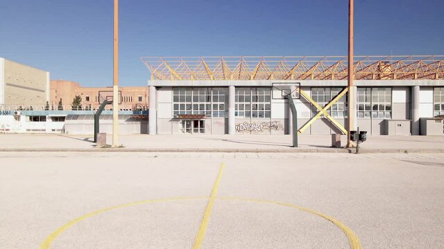 4K low angle drone clip flying through baskeball courts in a sports complex in Thessaloniki, Greece