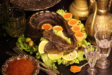 Baked sturgeon with black and red caviar, white wine and vodka
