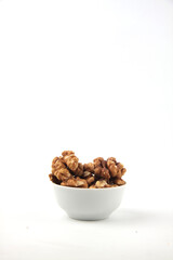 a bowl of walnut against white background vertical image
