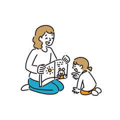 お母さんに絵本を読み聞かせしてもらう女の子