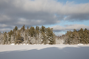 Snow covered lake and wintery sky in Algonquin Park