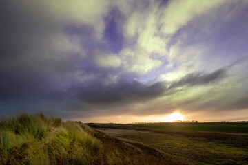 Fototapeta na wymiar Sunset in the Field and Dunes