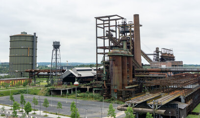 Fototapeta na wymiar Blast Furnace in Dortmund, Germany. The coal mining and steel in the region collapsed and nowadays this colossal buildings are abandoned and unused.