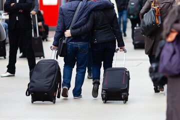 people with trolley bags in the city