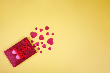 Happy Valentine's Day flatlay. Top view present gift box, hearts, glasses on on yellow color of the year 2021 background background. Valentine day or New Year greeting card