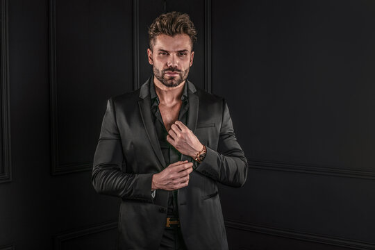 Elegant,handsome man posing in black fashionable suit,