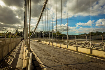 A view along the Clifton Suspension bridge over the River Avon on a bright Autumn day