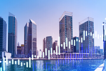 Fototapeta premium Skyscrapers of Dubai business downtown. International hub of trading and financial services of Western Asia. FOREX graph and chart concept. Double exposure. Dubai Canal waterfront.