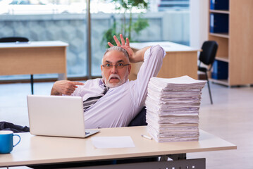 Aged businessman employee unhappy with excessive work