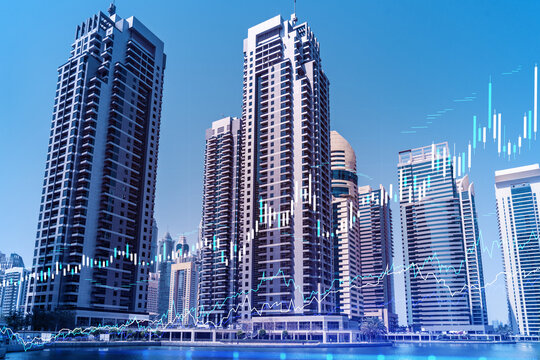 Skyscrapers of Dubai business downtown. International hub of trading and financial services of Western Asia. FOREX graph and chart concept. Double exposure. Dubai Canal waterfront.
