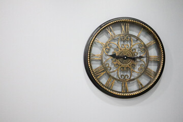 old design clock on the white wall interior