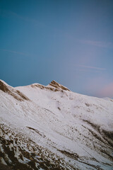 Snowy Orhi mountain in Pyrenees illuminated by sunrise light