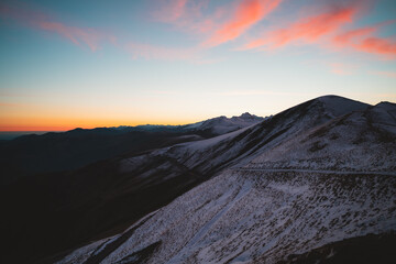 Snowy hills of Larrau mountain pass just before sunrise
