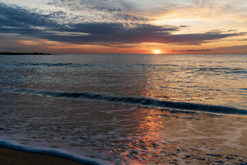 Fototapeta premium Sunrise over the Mediterranean Sea. Beautiful reflection of the sun in the water. Spain, Barcelona.