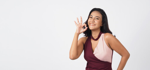 Fototapeta na wymiar Asian sexy woman do ok hand sign on white background.she has Tan skin or hazelnut skin tone.