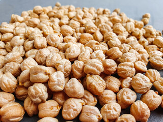 Uncooked dried chickpeas. Top view. Food background. Heap of legume chickpeas background 