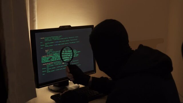 Hacker looking for a flaw in the program code.