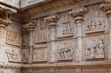 Fototapeta na wymiar Hampi, Karnataka, India - November 4, 2013: Hazara Rama Temple. group of Frescoes on beige stone walls of building.
