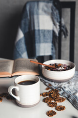 Homemade granola with figs, berries, honey. Cup of coffee and coffee pot. Breakfast.