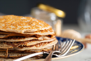 buckwheat pancakes with honey on a vintage plate