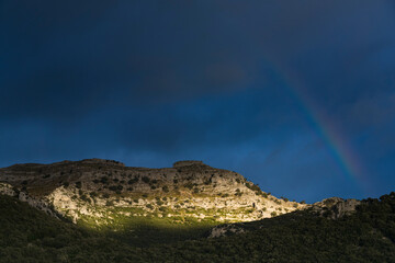 Fototapeta na wymiar Rainbow over Monte Candina in Liendo. Liendo Valley in the Eastern Coastal Mountain. Cantabria, Spain, Europe